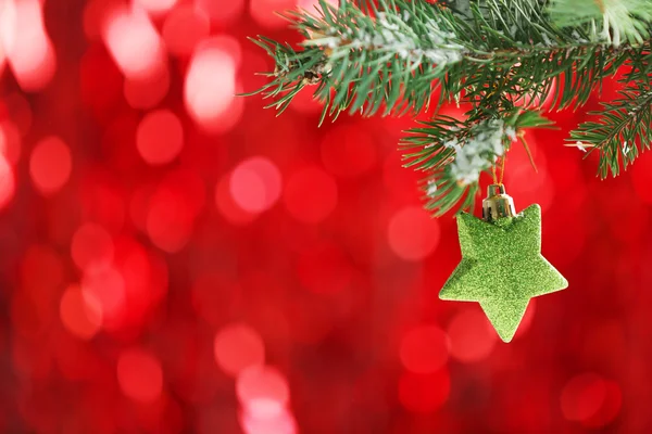 Christmas toy on a fir branch and glitter background — Stock Photo, Image