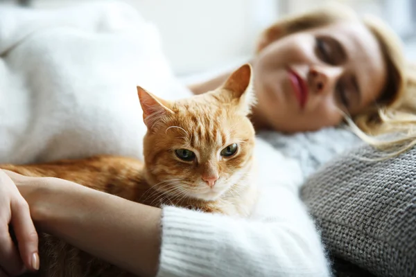 Mulher atraente que coloca com gato vermelho — Fotografia de Stock