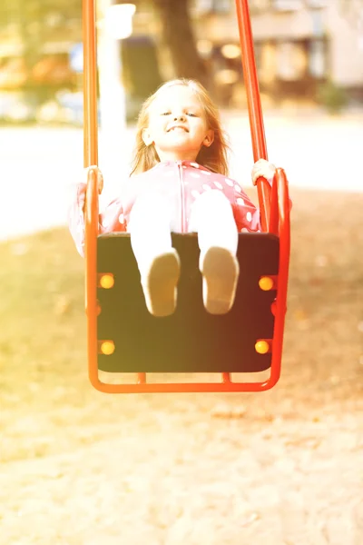 Girl having fun on swing — Stock Photo, Image