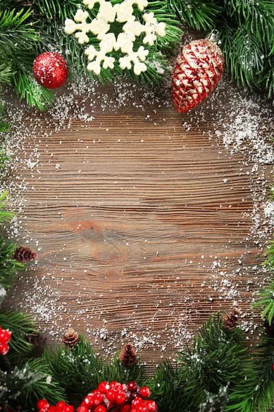 Christmas fir tree branches with rowan and toys on wooden table — Stock Photo, Image