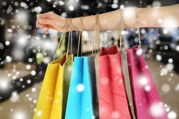 Hand with shopping paper bags — Stock Photo, Image