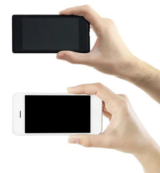 Ruce držící černé a bílé chytré telefony, izolovaných na bílém — Stock fotografie