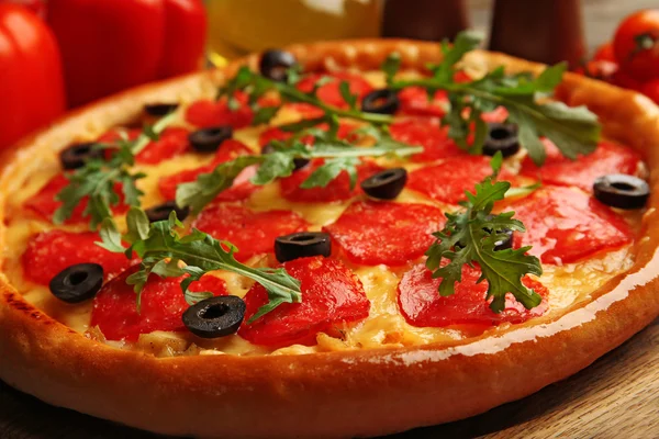 Tasty pizza with salami on decorated wooden table, close up — Stock Photo, Image