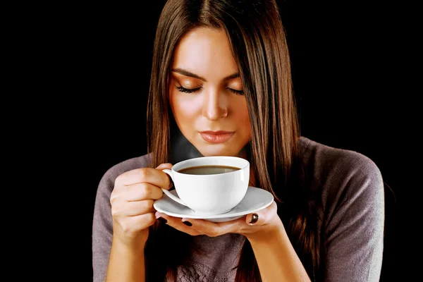 Woman holds cup of coffee and saucer in hands, close up — Stock Photo, Image