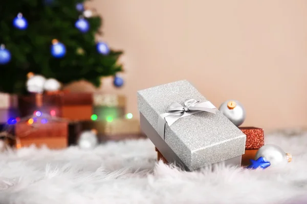 Christmas tree and presents on a carpet closeup — Stock Photo, Image