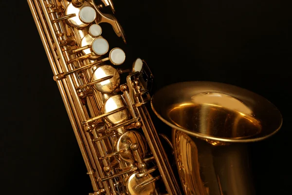 Beautiful golden saxophone on black background, close up — Stock Photo, Image