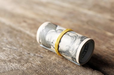 Dolar ahşap arka plan üzerinde rulo