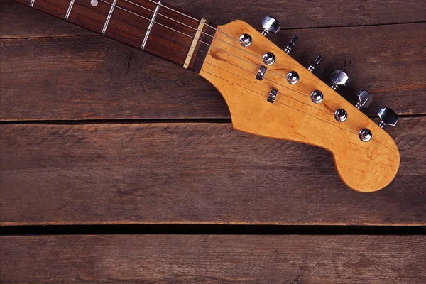 Electric guitars neck on wooden background, close up — Stock Photo, Image