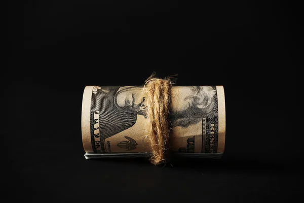 Dollars roll on black background — Stock Photo, Image