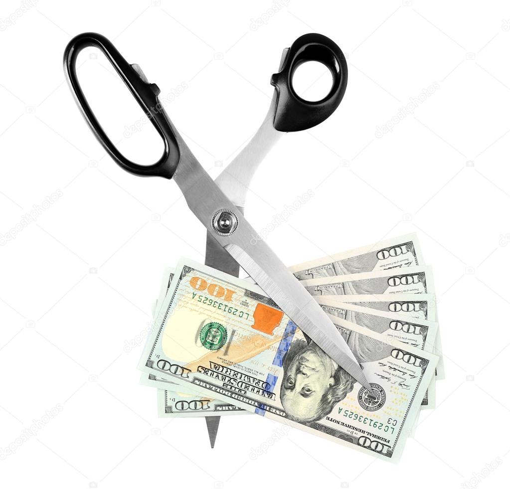 Scissors cut dollar banknotes