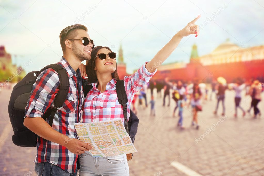 Happy tourists with map 