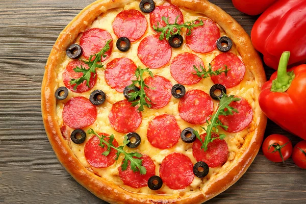 Tasty pizza with salami and red vegetables — Stock Photo, Image