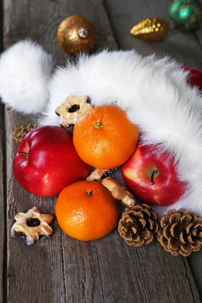 Santa hat filled with Christmas gifts — Stock Photo, Image