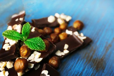 Renk ahşap arka plan üzerinde Fındıklı çikolata parçaları