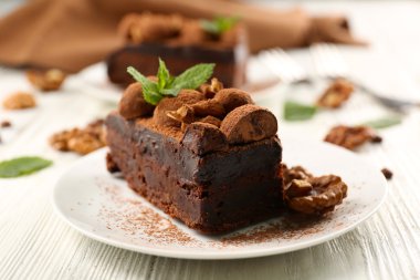 Masanın üzerinde nane ve ceviz ile çikolatalı kek parçası yakın çekim