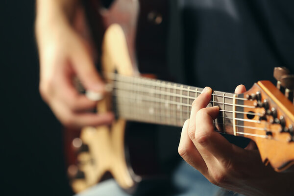 musician playing acoustic guitar 