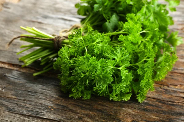 Fresh parsley on wooden background