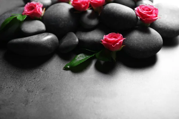 Spa composition of stones and flowers, on grey background — Stock Photo, Image