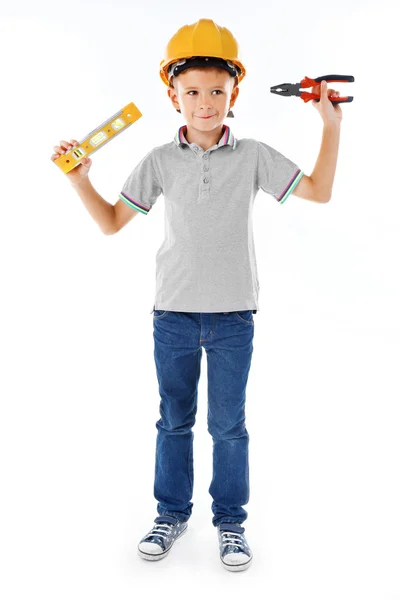 Menino em capacete amarelo com equipamento de construção — Fotografia de Stock