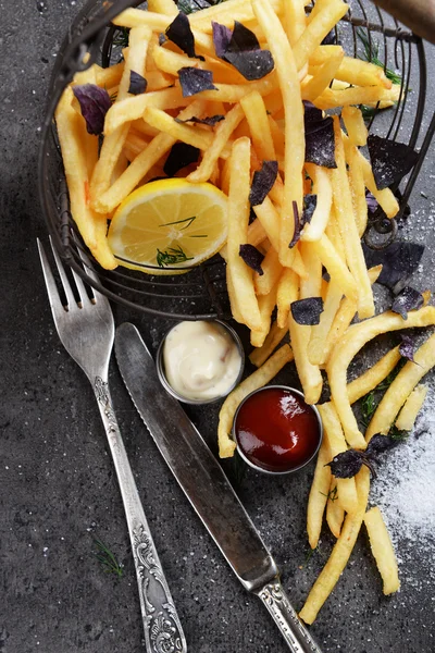 French fries with sauce and tableware on table — Stock Photo, Image