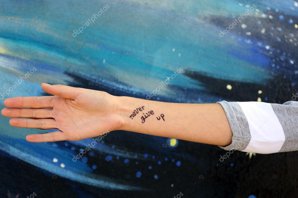 Female hand with tattoo Stock Photo by ©belchonock 93778436