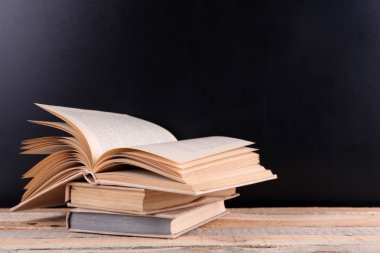 Tahta masadaki kitap yığını.