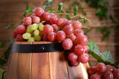 Grape and barrel on wooden table