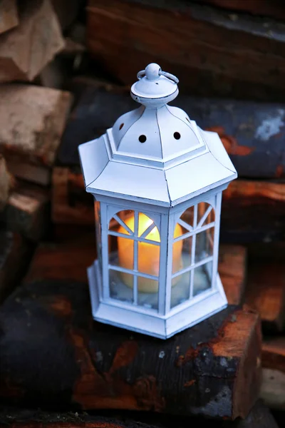 Lantern with candle on stack — Stock Photo, Image