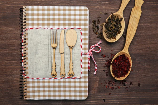 Decorated cookbook on wooden background — Stock Photo, Image
