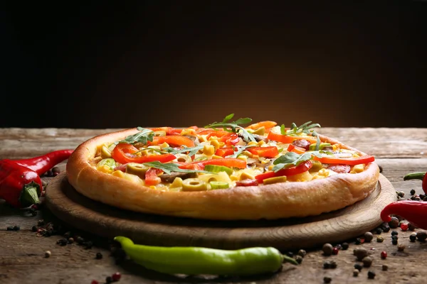 Pizza deliciosa com pimenta no fundo marrom — Fotografia de Stock