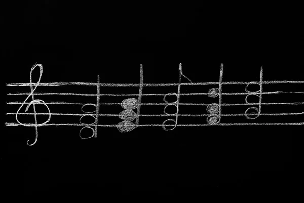 Ένα μαυροπίνακα με μουσικές νότες — Φωτογραφία Αρχείου