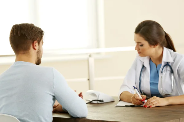 Female doctor examining patient blood pressure — Stock Photo, Image