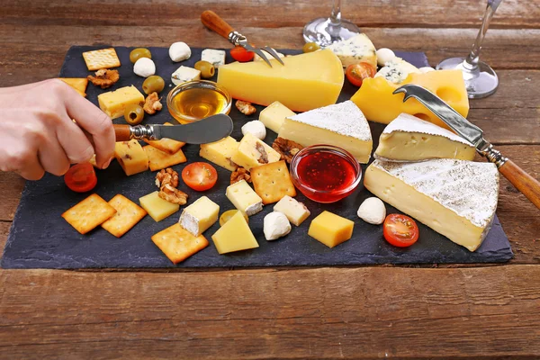Cheese for tasting on wooden table — Stockfoto