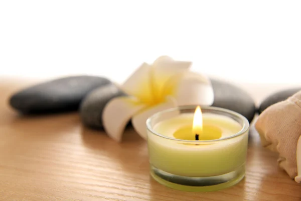 Plumeria and candle on light background — Stock Photo, Image