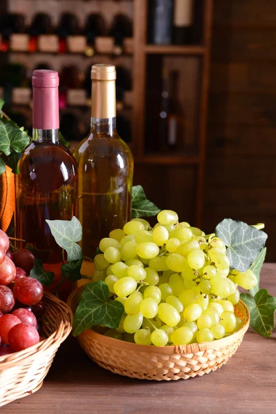 Виноград с вином и бочкой на столе — стоковое фото