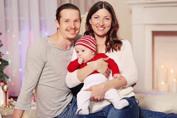 Parents playing with baby in Christmas room — Stock Photo, Image