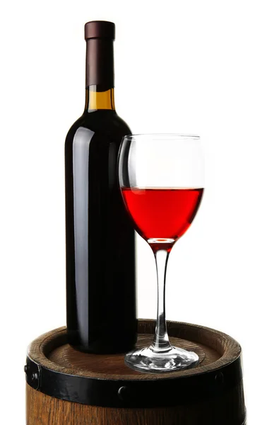 Red wine in glass and in bottle standing on barrel isolated on white — Zdjęcie stockowe