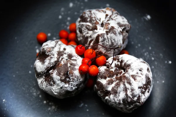 Chocolate balls with ash berry on plate closeup