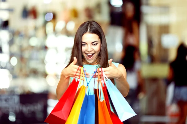 Beautiful young woman with bags — Stock Photo, Image