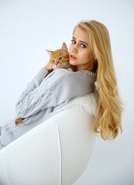 Young woman with red cat Stock Picture