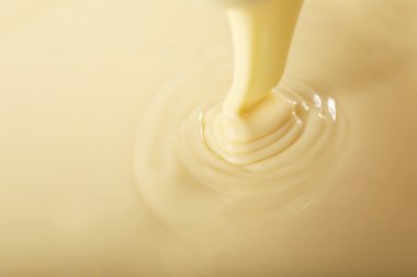 Background of condensed milk in a bowl, close-up clipart