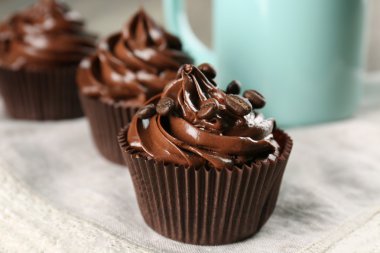 Chocolate cupcakes and drink on white napkin, closeup