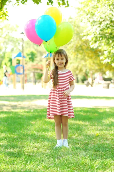 Little girl with balloons — Stock Photo, Image