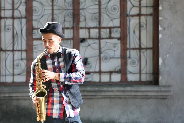 Un joven toca el saxofón —  Fotos de Stock