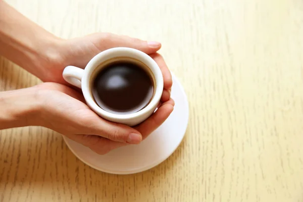 Cup of coffee with hands — Stock Photo, Image