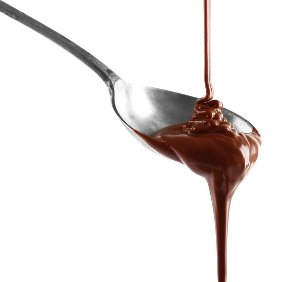 Melted milk chocolate pouring from a spoon, isolated on white — Stock Photo, Image