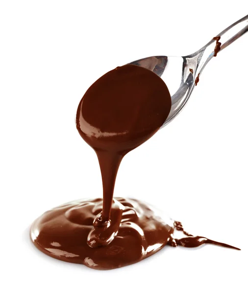 Melted milky brown chocolate pouring from a spoon, isolated on white — Stock Photo, Image