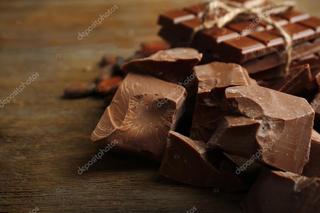 Chocolate Pieces Shavings And Cocoa Beans On Color Wooden Background Stock Photo By C Belchonock