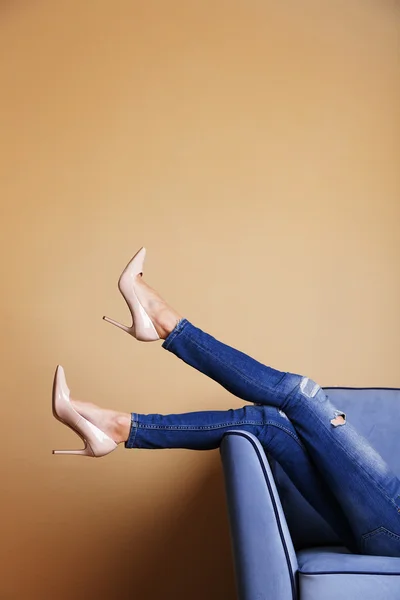 Woman legs on sofa — Stock Photo, Image