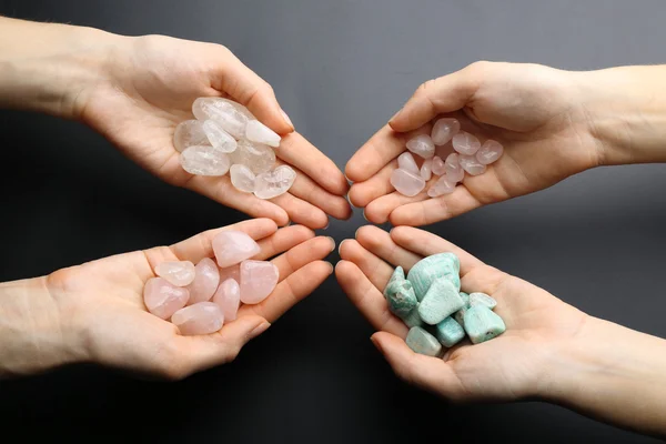 Women holding semiprecious stones — Stock Photo, Image